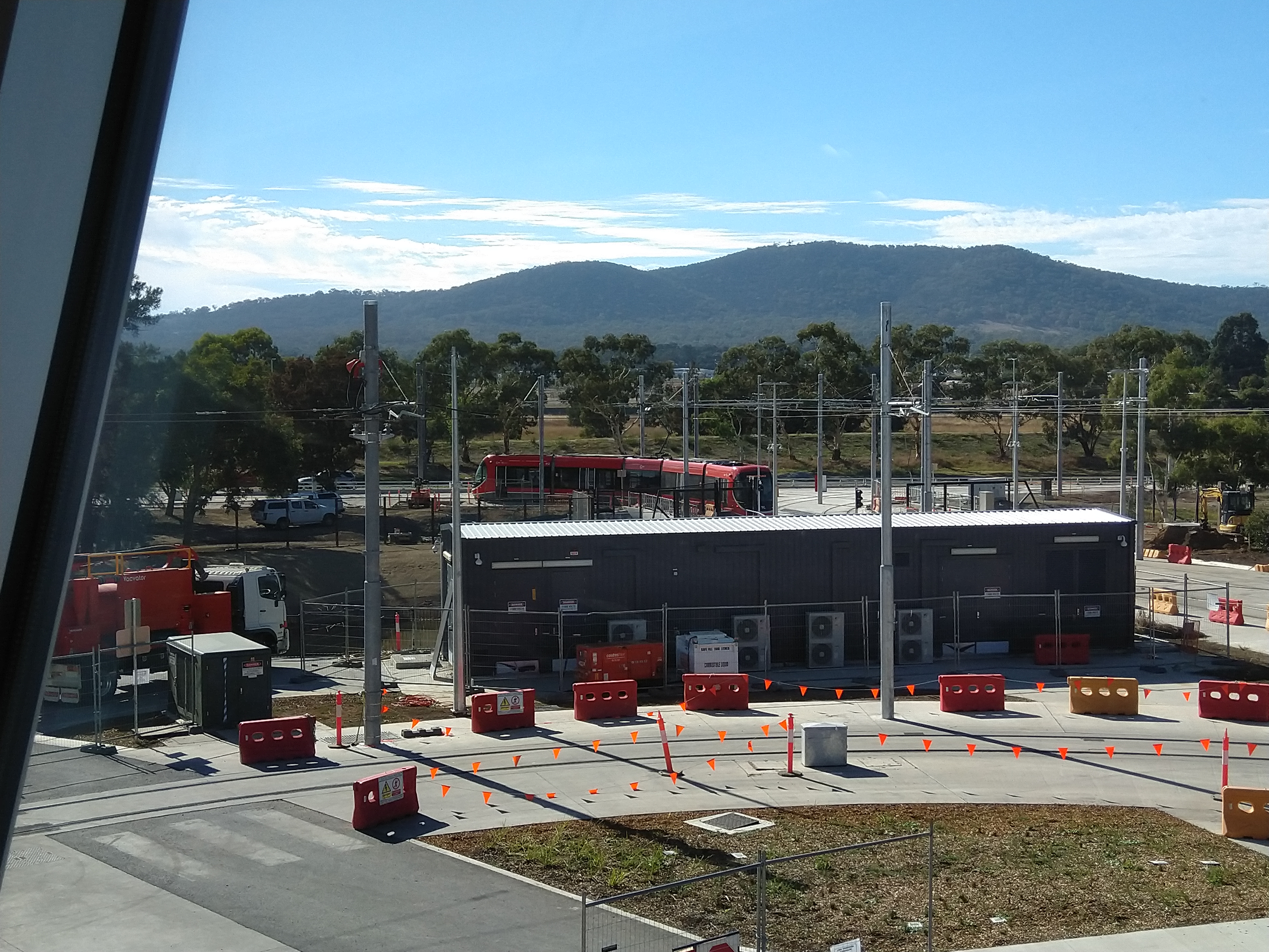 View from the control centre of the entrance and exit from the Mitchell light rail depot to Flemington Rd. Thats a large substation and in front of that is the track into and out of the workshop area.